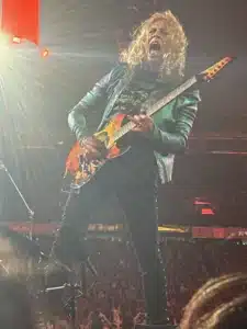 Kirk Hammett performing a guitar solo on stage during Metallica’s M72 Santa Clara show, spotlighted under dramatic lighting at Levi’s Stadium.